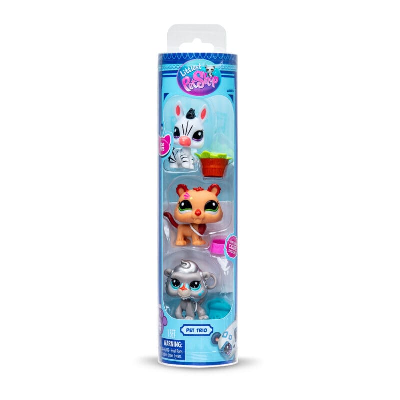 621_Image2 Packaging of a Littlest Pet Shop 'Pet Trio' set, featuring three toy figures in a vertical blister pack. At the top is a white zebra with black stripes and a pink nose, accompanied by a bucket of lettuce. In the middle is an orange lion with a star on its face. At the bottom is a gray monkey with blue eyes, next to a blue jar with a paw print. The packaging is blue with the Littlest Pet Shop logo at the top and age recommendation of 4+.